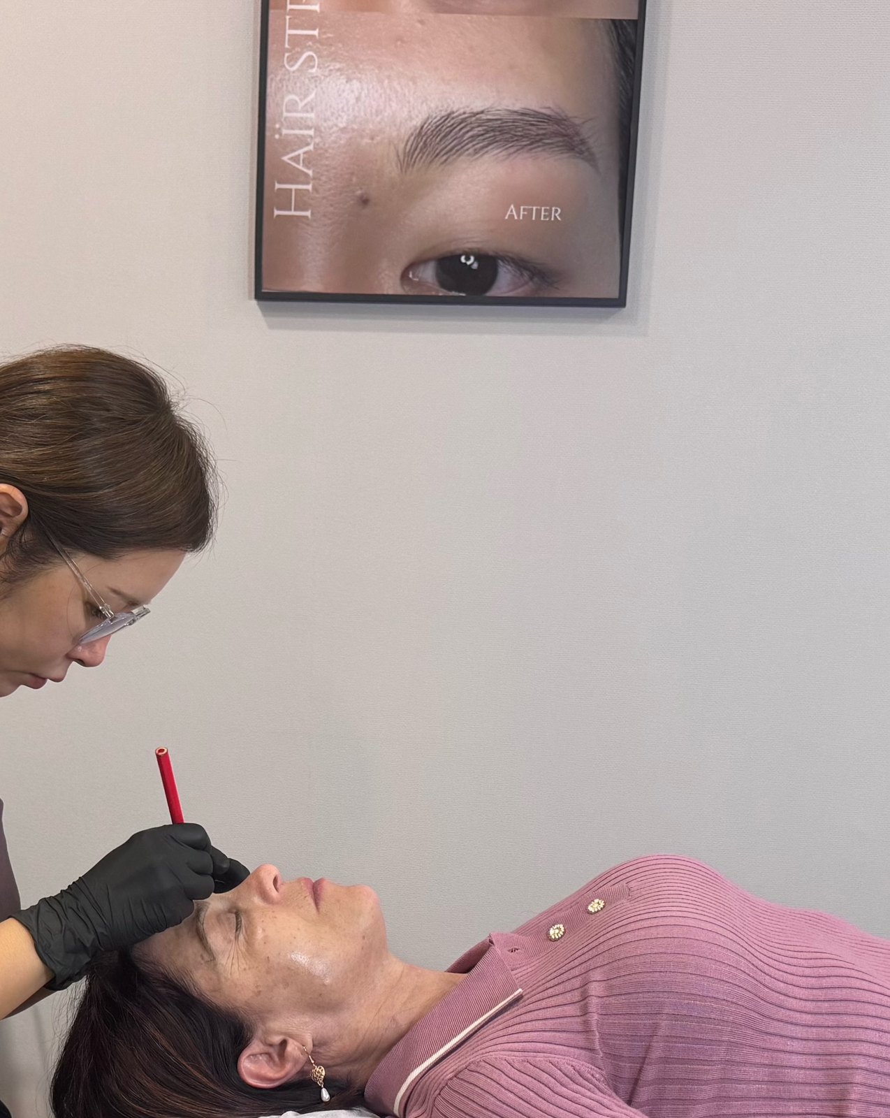 Root Chungdam artist drawing individual brow hair strokes by machine at Tune Clinic