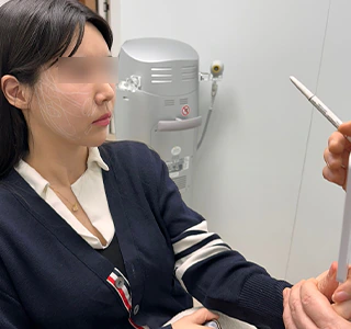 Patient reviewing the first-stage facial design in a mirror